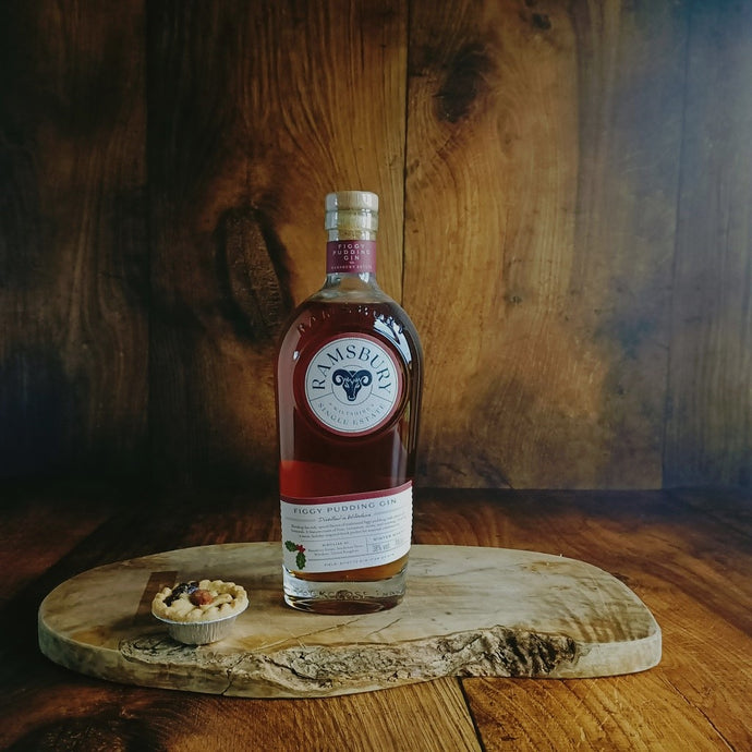Bottle of Figgy Pudding Gin on a wooden board with a rustic background