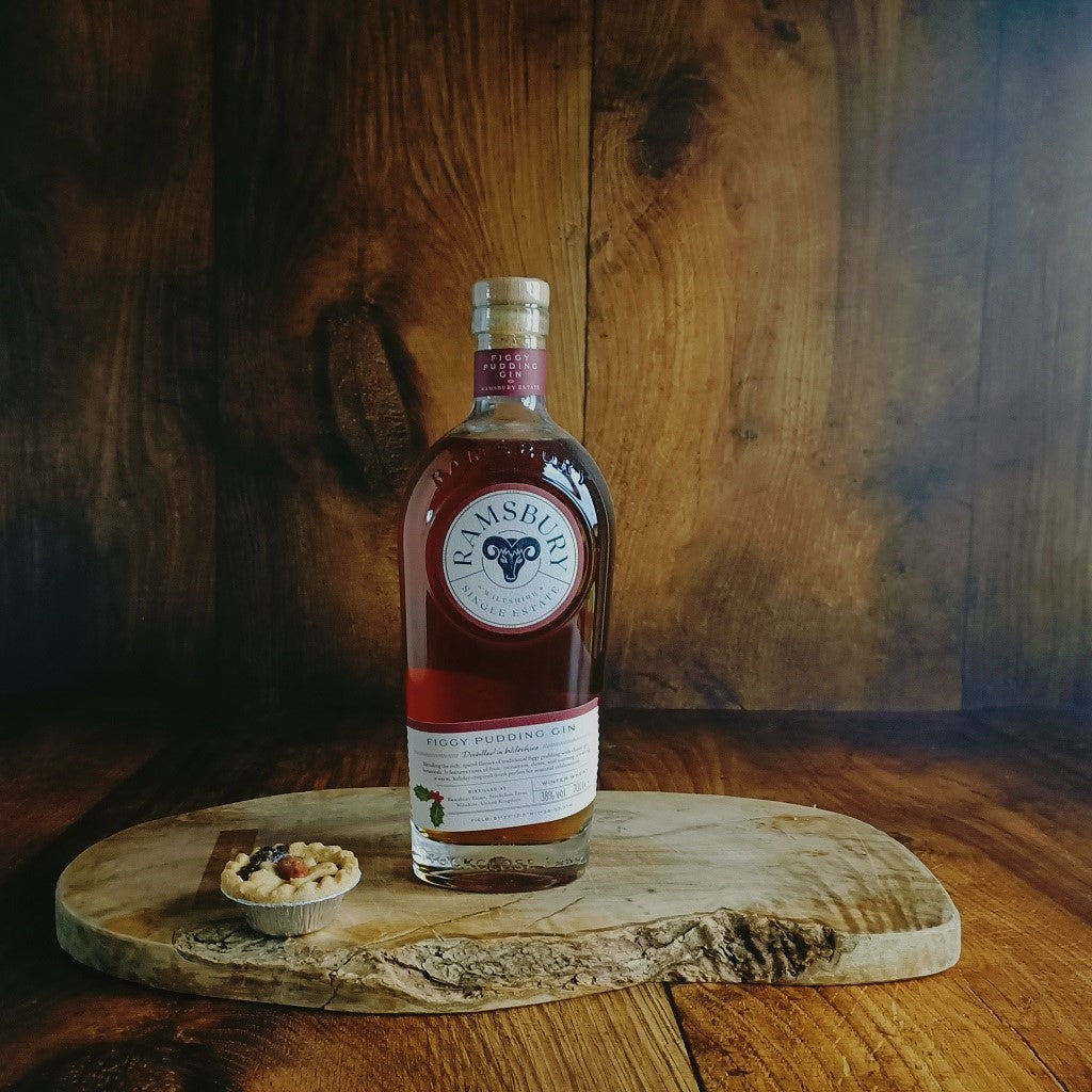 Bottle of Figgy Pudding Gin on a wooden board with a rustic background